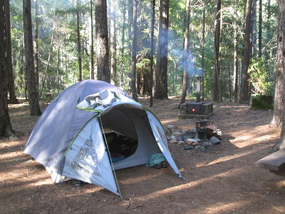 a campsite with tent and
        fire pit